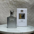 Creed Himalaya perfume bottle and packaging on a textured surface with flowers in the background.