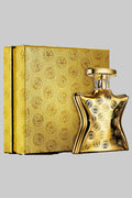 Gold perfume bottle and packaging with intricate design on a white background