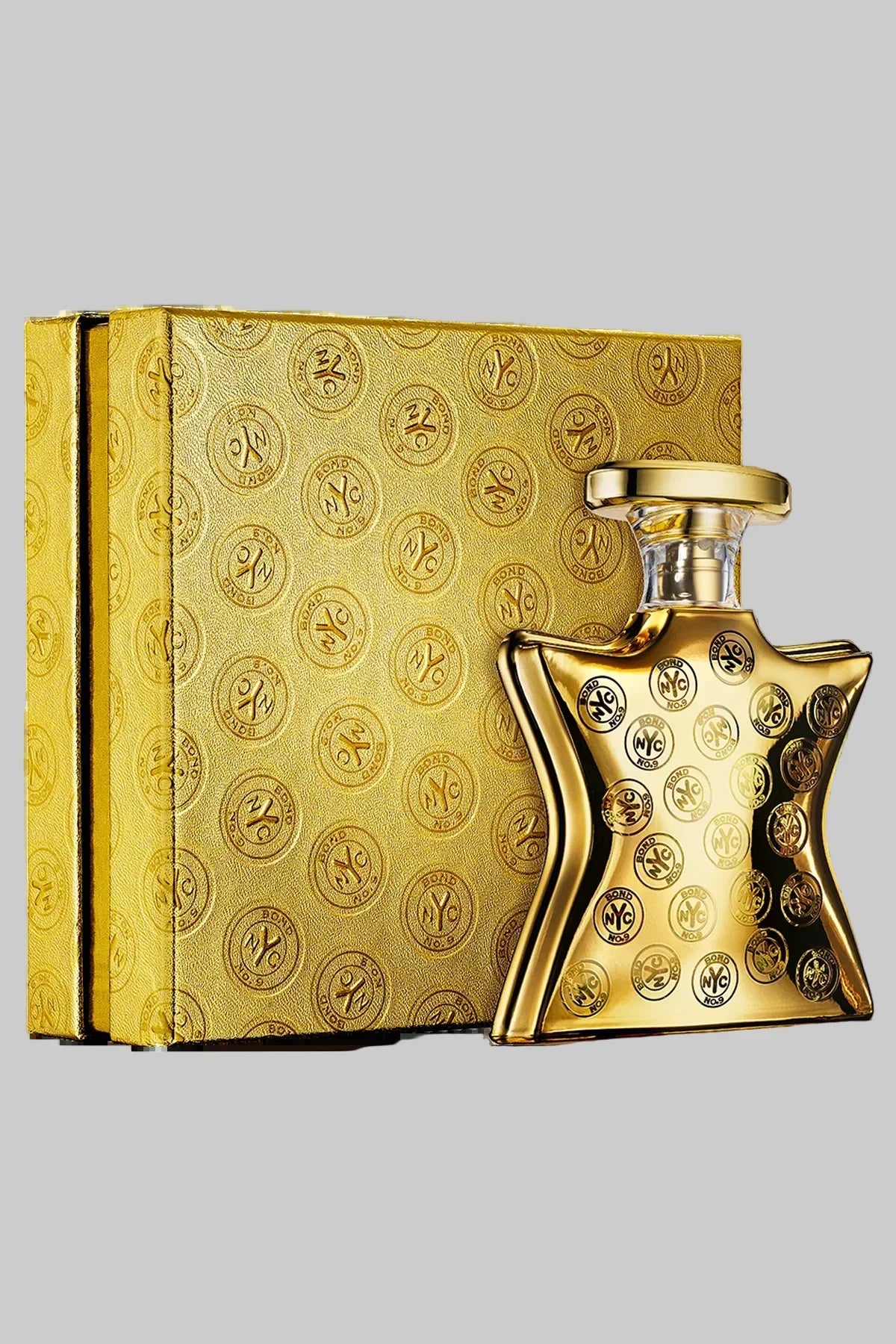 Gold perfume bottle and packaging with intricate design on a white background