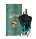 Jean Paul Gaultier perfume bottle and green cylindrical container on a white background