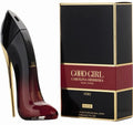 Black high-heeled shoe and Carolina Herrera 'Good Girl' perfume box on a white background